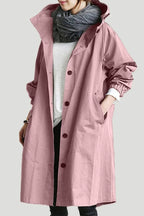 Pink hooded longline trench coat with button front, shown draped over a slim silhouette
