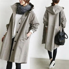 Close-up of the pink hooded trench coat highlighting the drawstring hood and elasticated cuff
