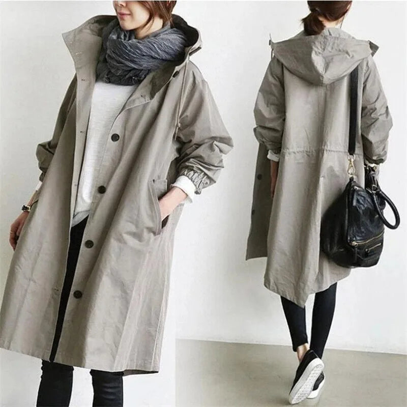 Close-up of the pink hooded trench coat highlighting the drawstring hood and elasticated cuff