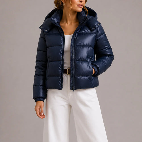 Close-up front view of the navy puffer jacket showing zip closure, hood snaps and quilted panels