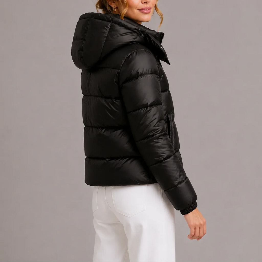 Back and side angle of the black puffer jacket highlighting the ribbed cuffs and rounded hood