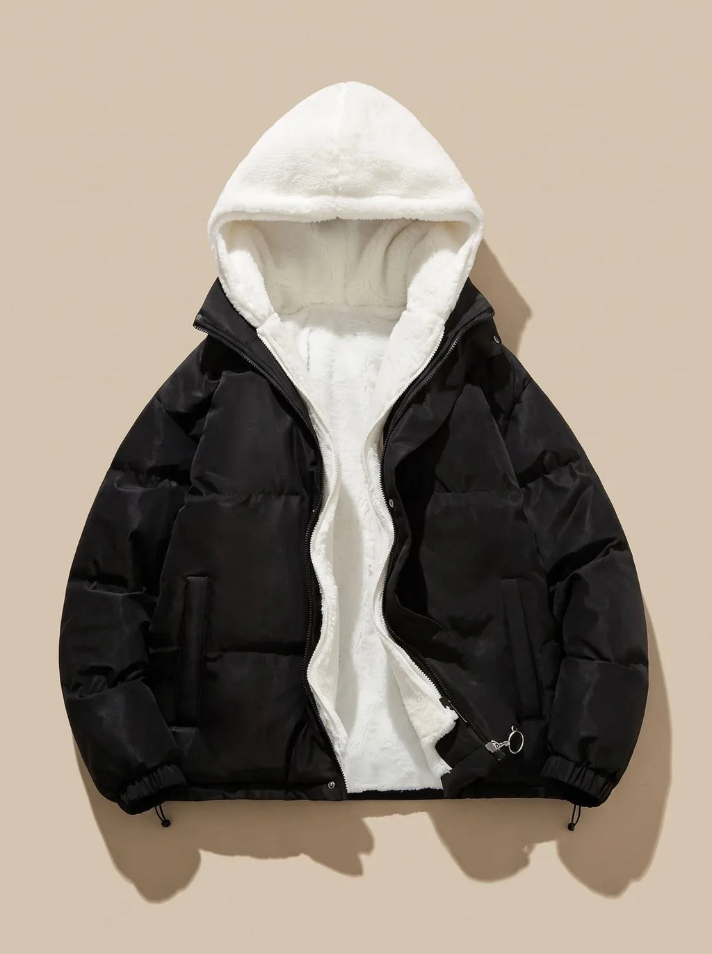 Black puffer jacket with hood fully open, laid flat, showing cream sherpa fleece hood lining