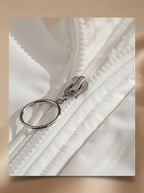 Back view of black puffer jacket on model showing quilted panels and relaxed silhouette