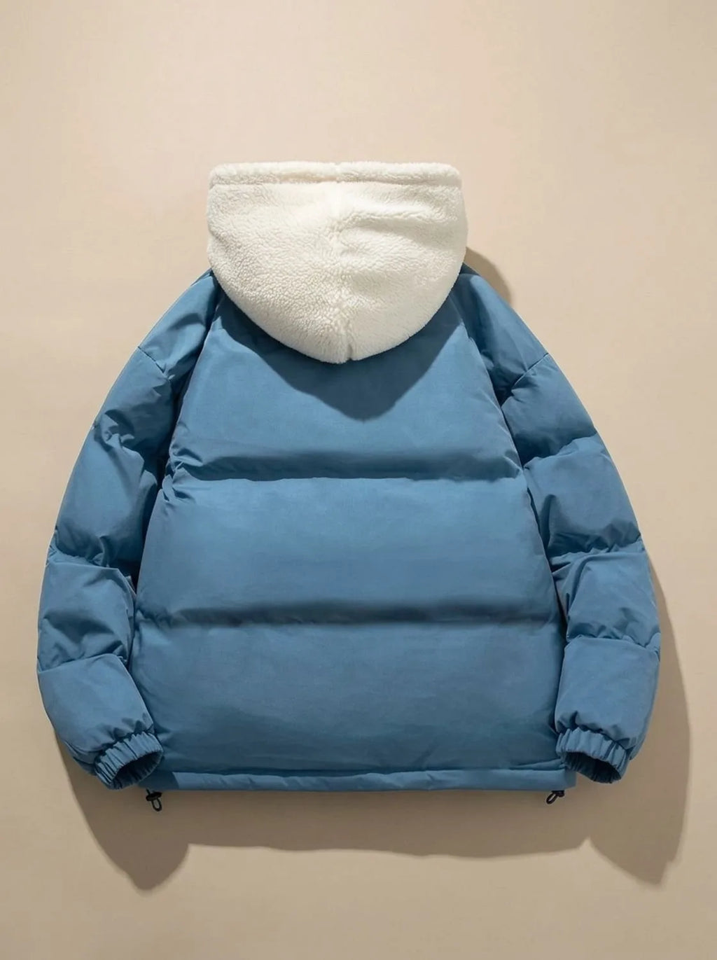 Front view of pink puffer jacket on model with hood down, showing collar and zip