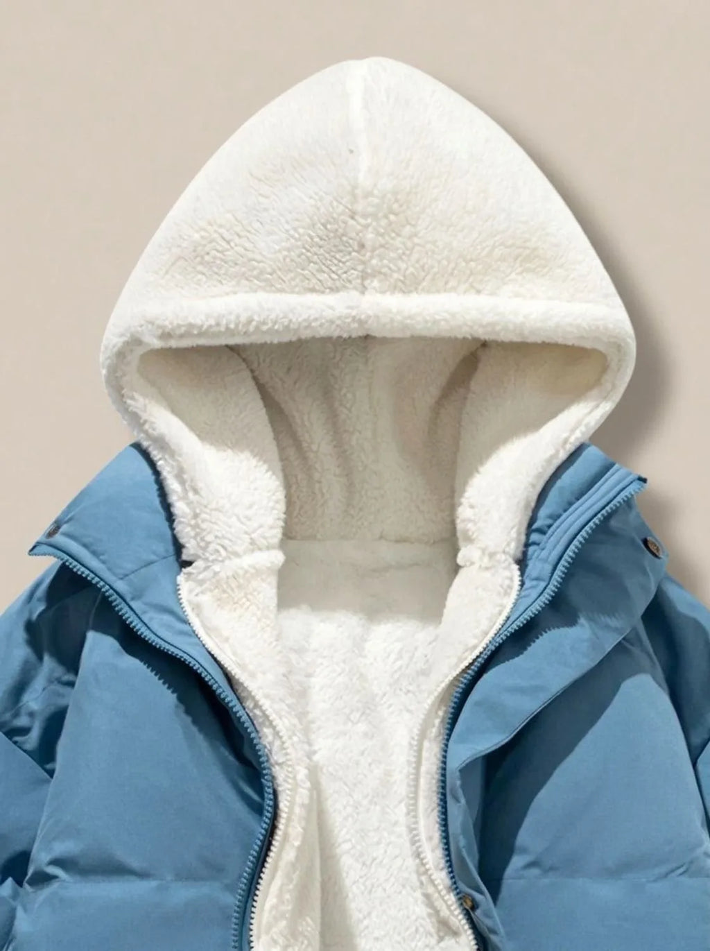 Side view of pink puffer jacket on model, showing oversized quilted sleeves