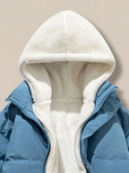Side view of pink puffer jacket on model, showing oversized quilted sleeves