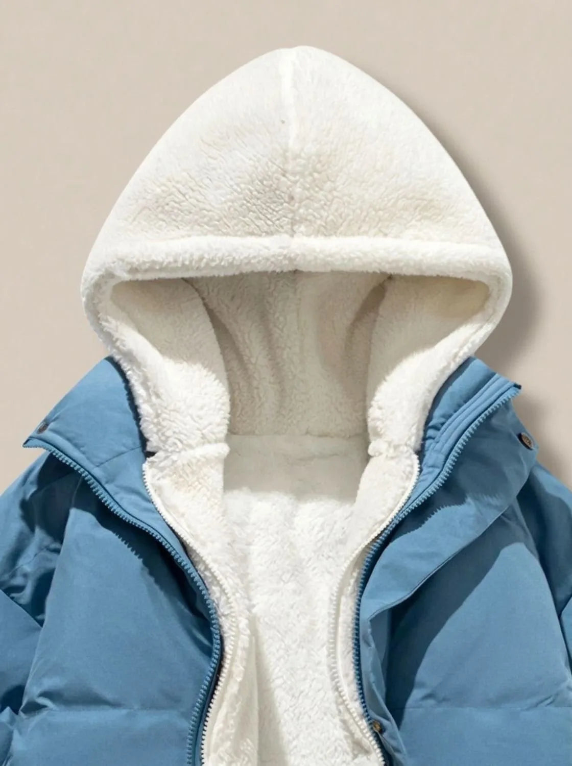 Side view of pink puffer jacket on model, showing oversized quilted sleeves