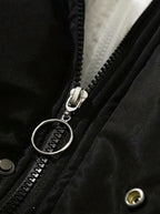 Close-up of black zip pull with silver ring detail and press stud fastening