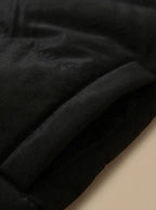 Close-up of side pocket and quilted panelling detail on black puffer jacket