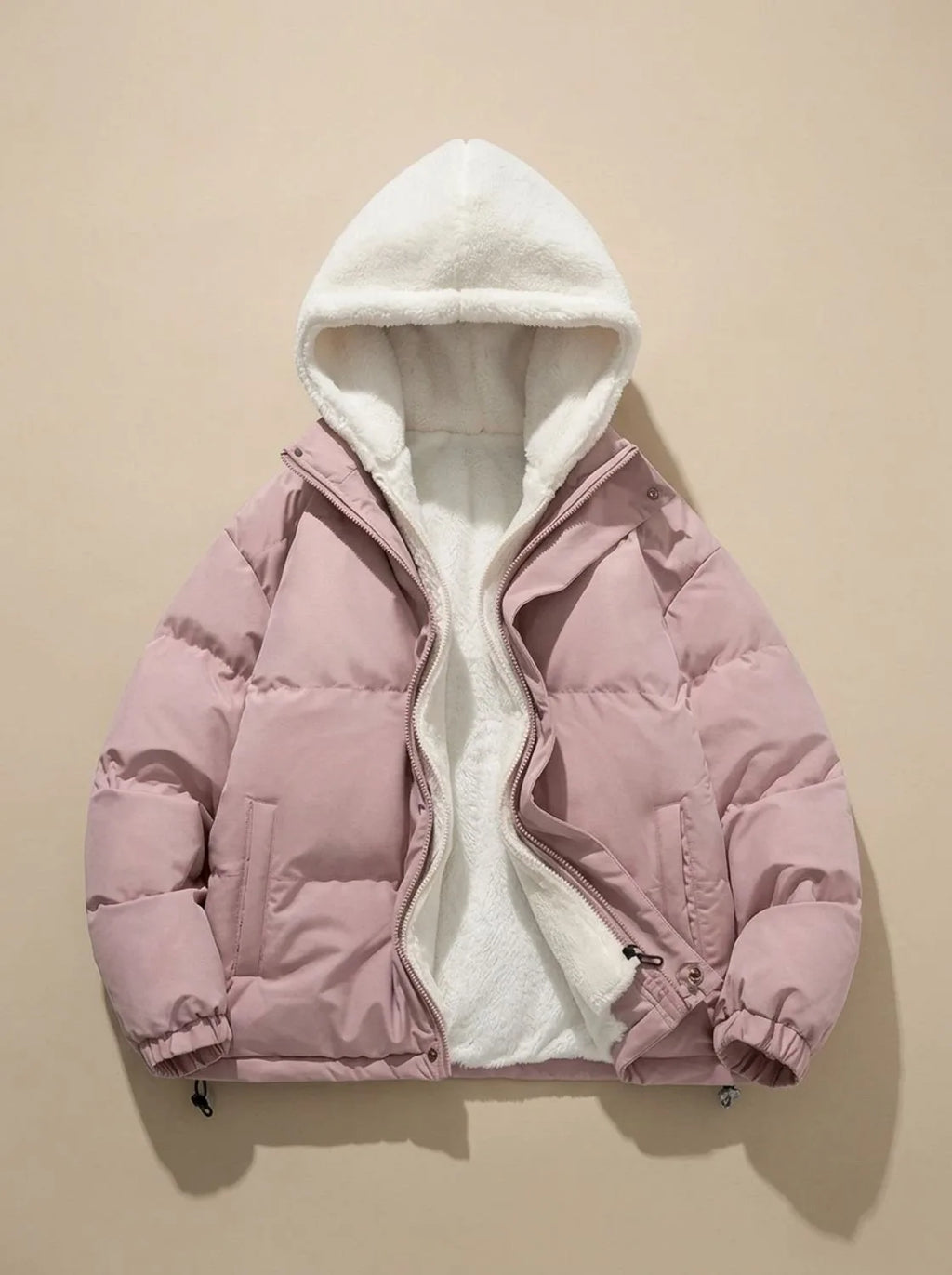 Pink puffer jacket laid flat with hood open, revealing cream sherpa fleece lining throughout hood
