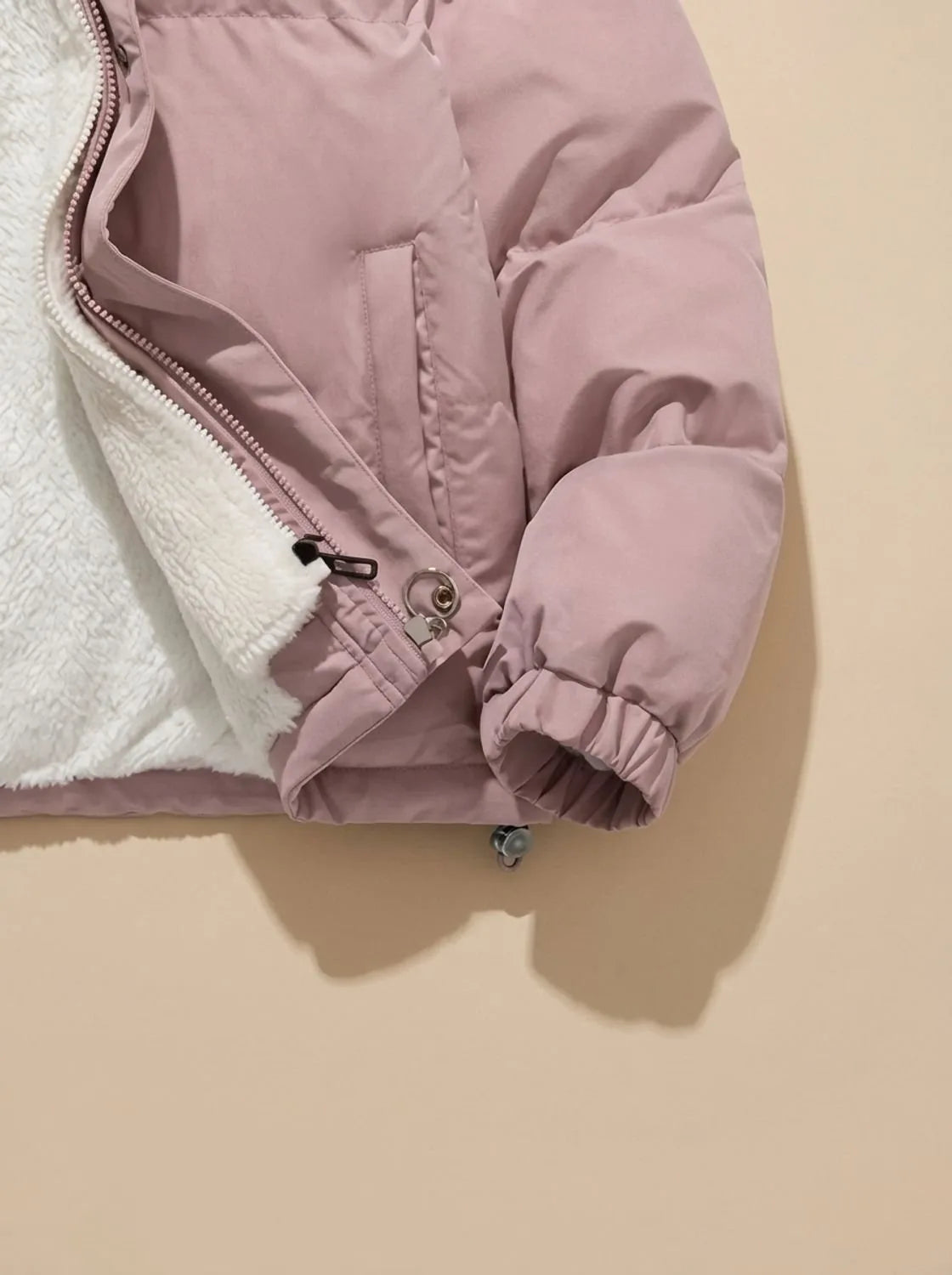 Front view of black puffer jacket with hood up, modelled, showing relaxed oversized fit