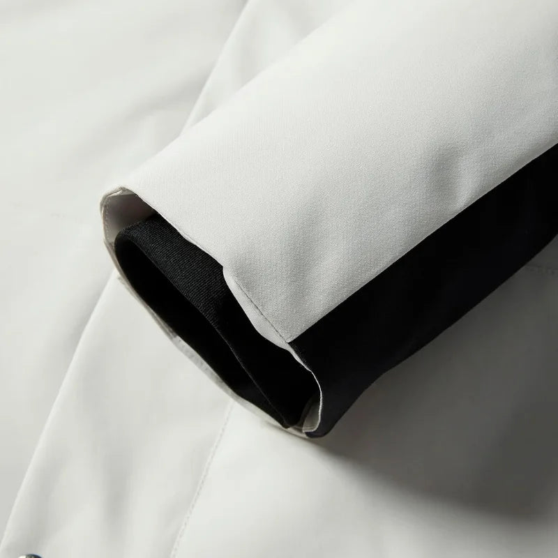 Detail of the jacket's hem and side seam showing fabric texture and stitched finish
