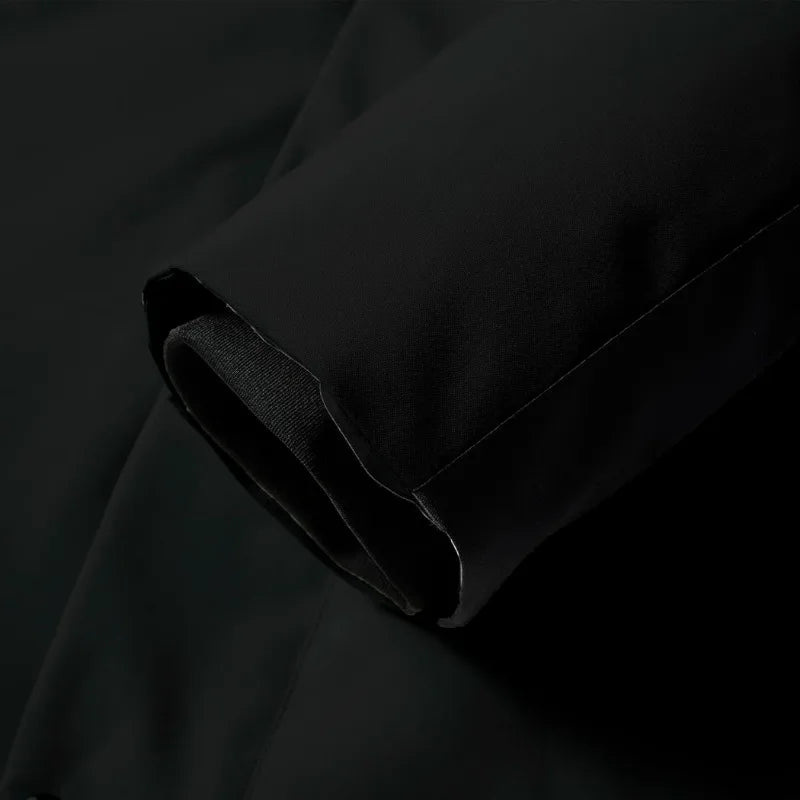 Close-up of the black fabric sleeve cuff with hook-and-loop adjustable tab for a snug fit