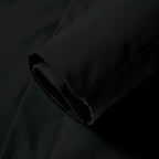Close-up of the black fabric sleeve cuff with hook-and-loop adjustable tab for a snug fit
