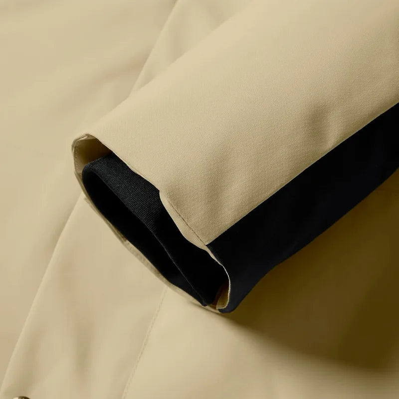 Close-up of khaki fabric cuff with black hook-and-loop strap for adjusting sleeve width