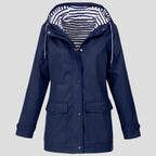 Navy blue hooded waterproof jacket with striped lining visible inside the hood and press-stud cuffs