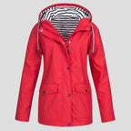 Red hooded rain jacket, fully zipped with popper storm flap and two flap-front pockets