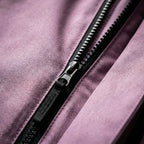 Close-up of the lilac fabric and matte black zip pull on the jacket's centre front closure