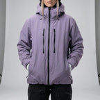 Model wearing the lilac hooded ski jacket fully zipped with hood up over a black beanie