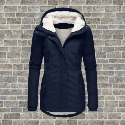 Navy blue hooded winter coat with sherpa fleece lining and zip front, shown flat against a brick wall