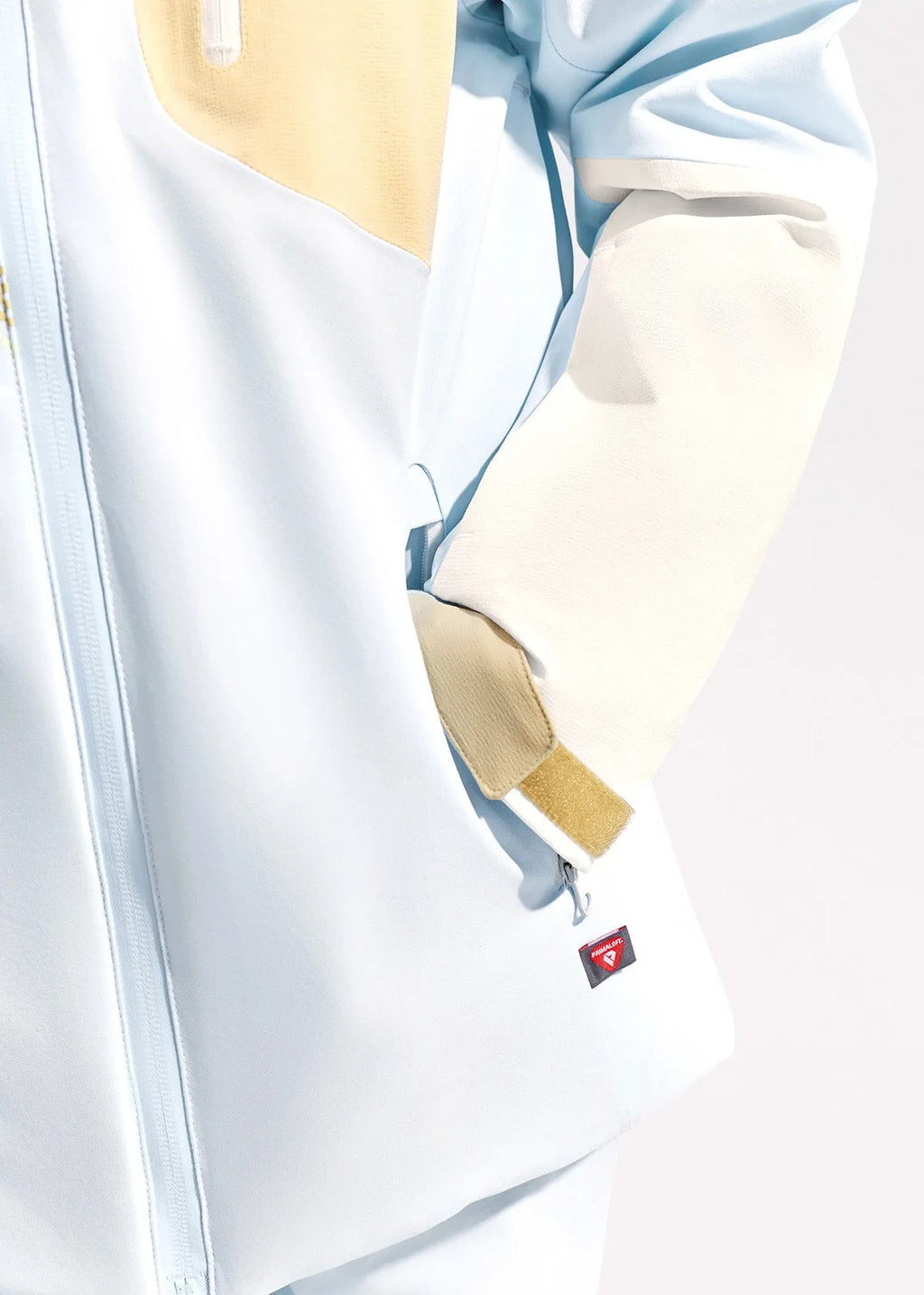 Detail shot of pale blue jacket side seam showing ventilation mesh panel and underarm zip vent
