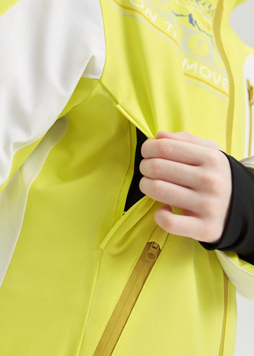 Close-up of a hand reaching into an interior zipped pocket beneath the front zip