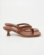 Chocolate brown leather sandal with crossover straps, square toe and sculptural heel, side profile