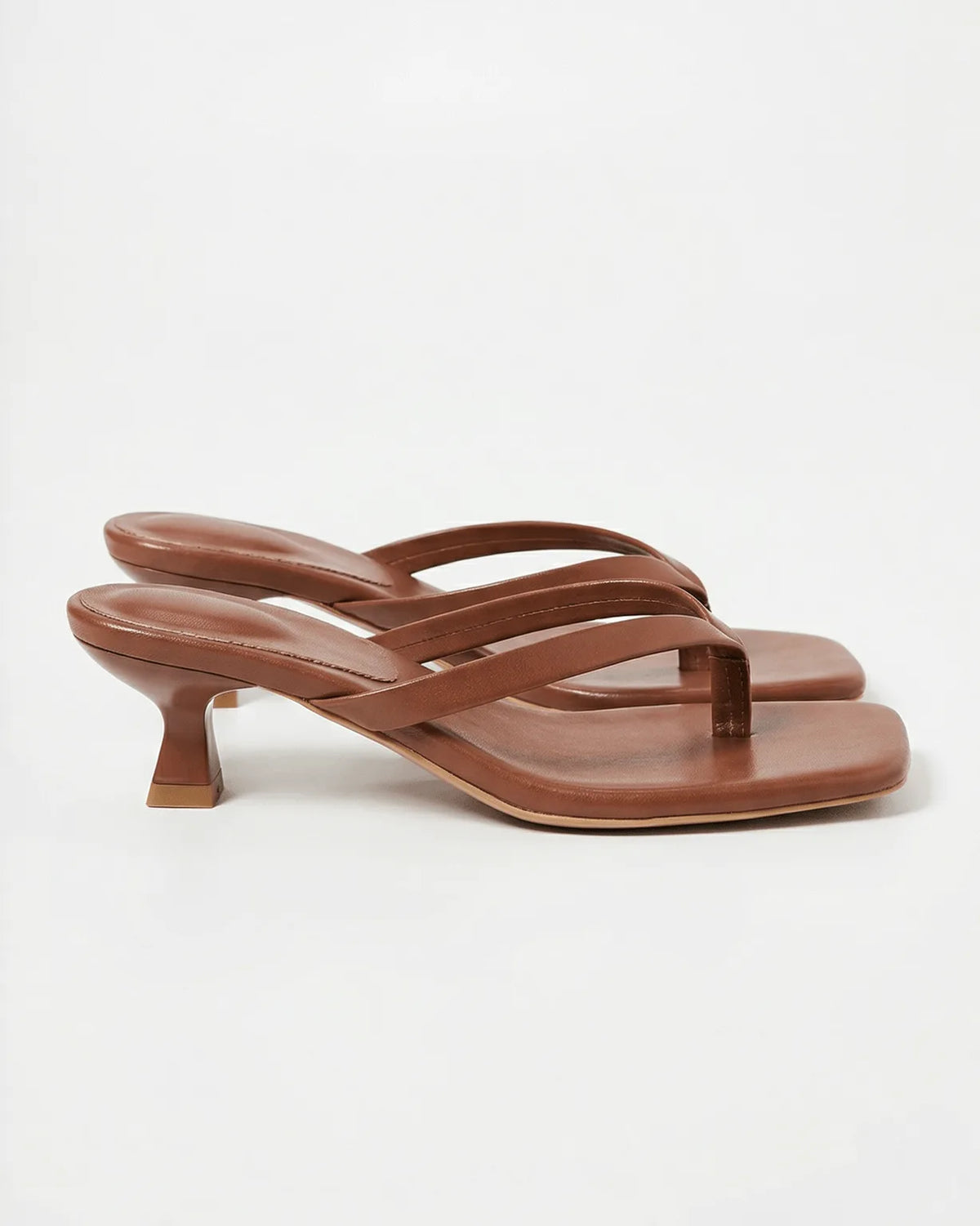 Chocolate brown leather sandal with crossover straps, square toe and sculptural heel, side profile