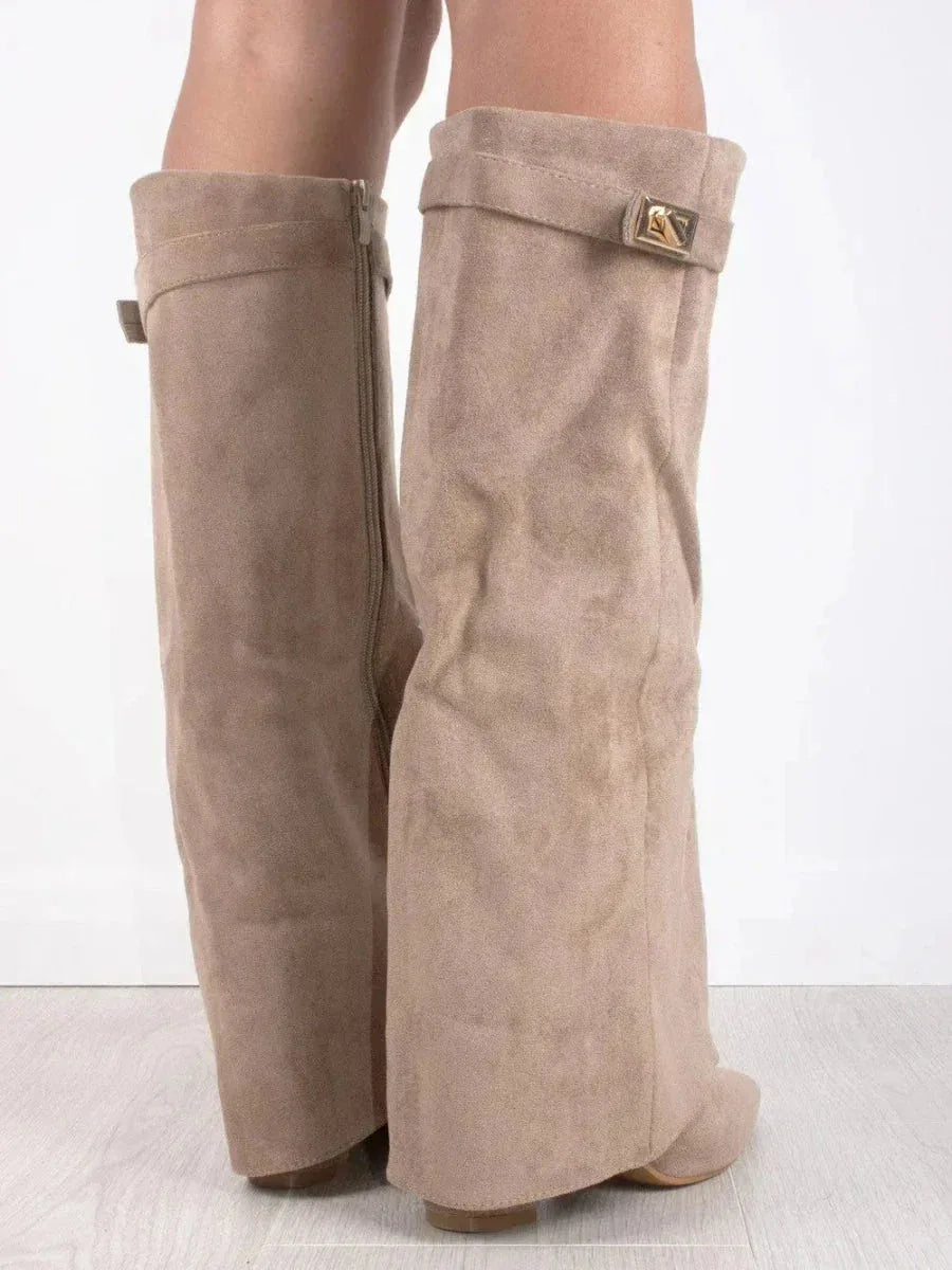 Back view of beige suede boots showing side zip, cuff strap with gold buckle and stacked heel