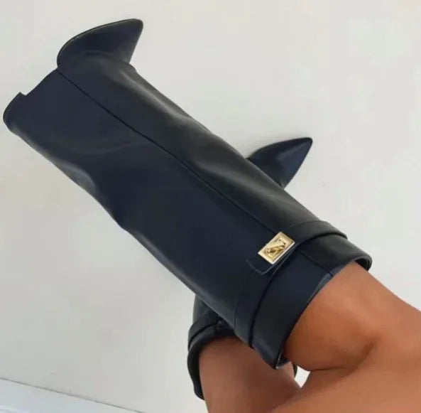 Close-up of black faux leather boot folded cuff with gold turn-lock buckle detail