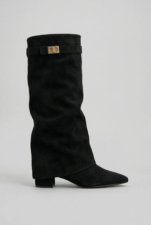 Side view of a black suede-look knee-high boot with a pointed toe, block heel and folded shaft with gold turn-lock strap