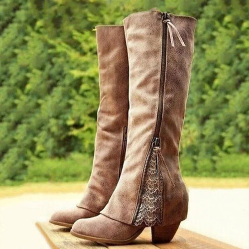 Side view of tall brown faux-leather boots with a lace panel at the ankle, zip fastening and stacked block heel