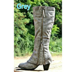 Grey knee-high boots displayed outdoors, highlighting the textured finish, zip trim and pointed toe