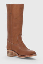 Side view of a black leather knee-high boot resting against a plain studio background