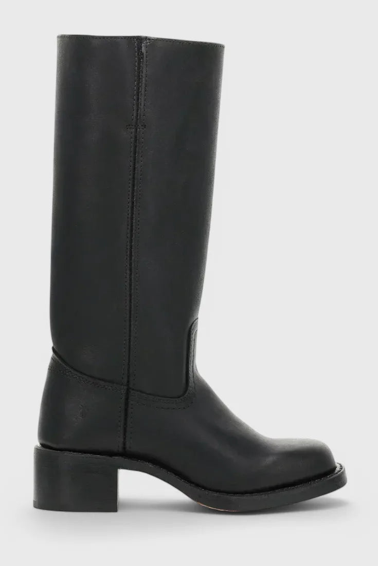 Close-up of the curved topstitching detail on the vamp of a dark brown leather boot