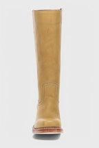 Side view of a tan leather knee-high boot showing the tall shaft and low stacked heel