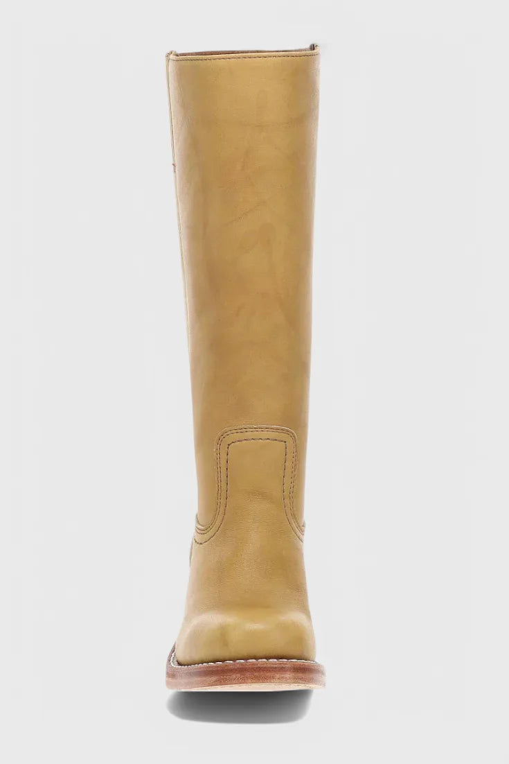 Side view of a tan leather knee-high boot showing the tall shaft and low stacked heel