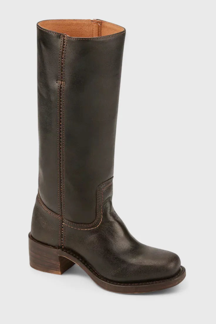 Interior view of a dark brown leather boot showing the tan lining and pull tab at the top