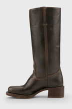 Angled view of yellow leather knee-high boots emphasising the smooth leather finish and heel shape