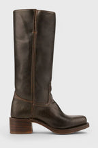 Close-up of the block heel and sole edge on a weathered brown leather boot