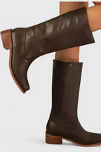 Side profile of a dark brown knee-high leather boot showing the pointed toe and low block heel
