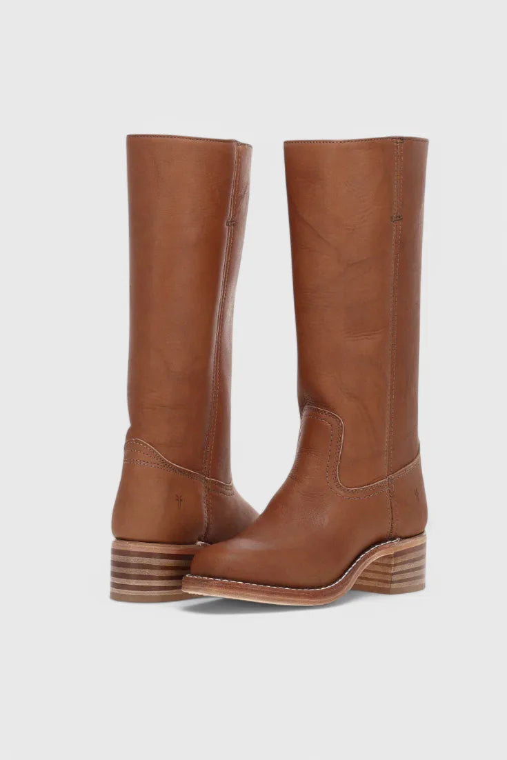 Front pair view of tan brown leather knee-high boots with contrast stitching and a striped stacked heel