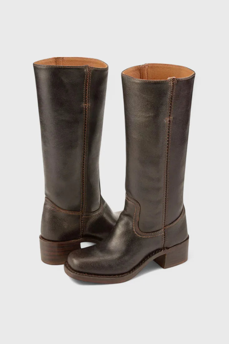Back three-quarter view of dark brown leather knee-high boots showing the tan interior lining and heel counter