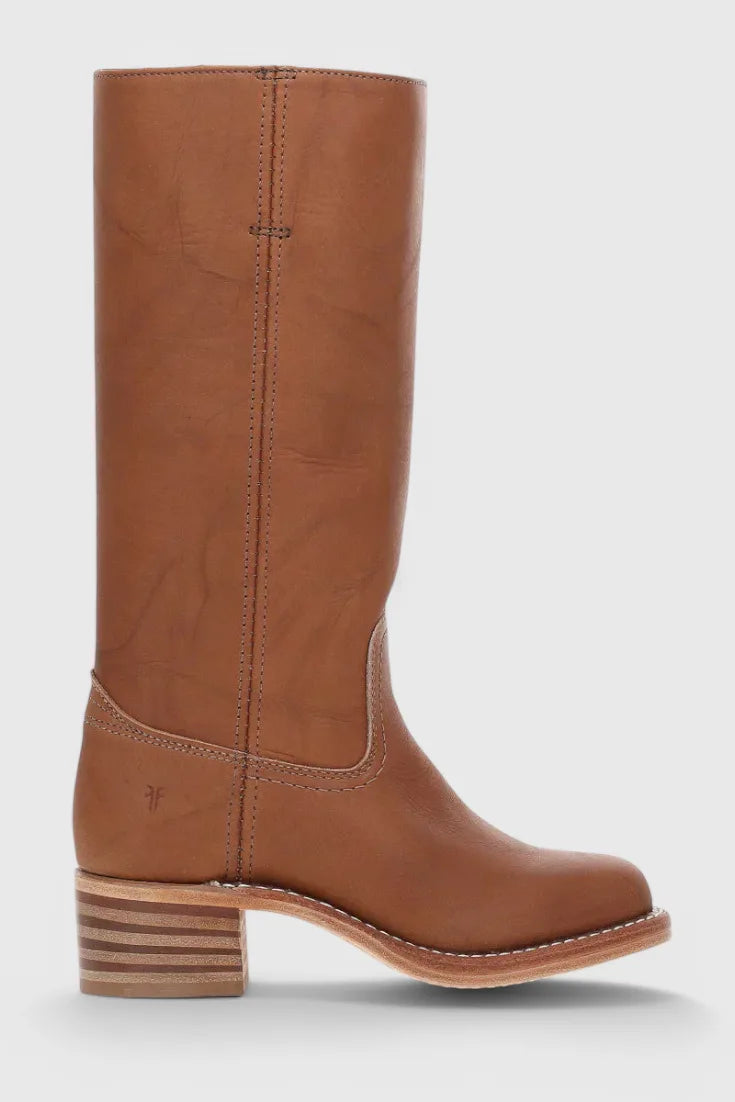 Close-up of the pointed toe and stitched vamp seam on a light brown leather knee-high boot