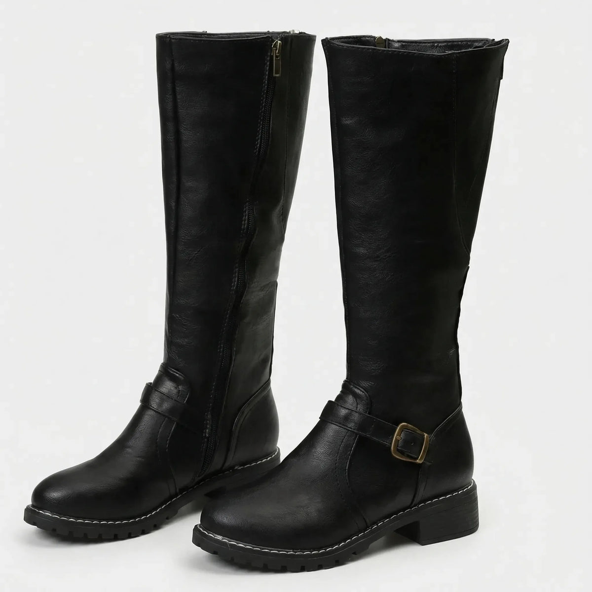 Black knee-high riding boots with visible side zip and ankle buckle strap, studio shot