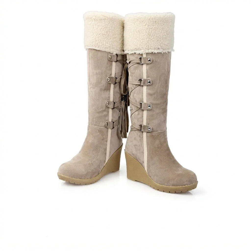 Front pair view of beige knee-high boots showing fold-down shearling cuffs and buckle straps