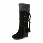 Side profile of black suede knee-high boot with grey knit-style cuff and buckle lacing