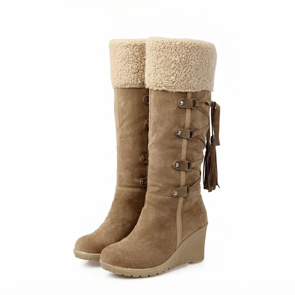 Front pair view of light brown knee-high boots with cream shearling cuffs and tassel ties