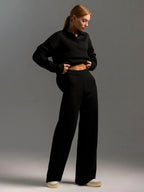 Front facing shot highlighting the soft knit texture of the brown polo jumper and trousers