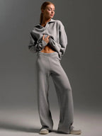 Close up of the elastic ribbed waistband on the cream knit wide leg trousers